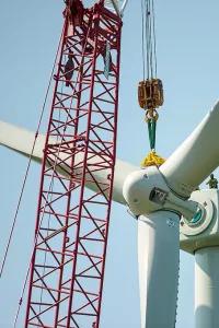 crane building a wind turbine