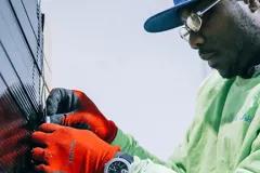 Man putting together elements of a solar panel