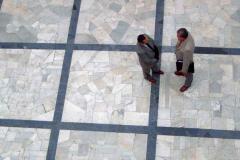 bird view of two men talking on city square