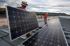 workers setting up solar panels